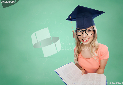 Image of student woman in mortarboard with encyclopedia