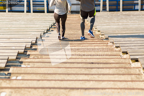 Image of close up of couple running downstairs on stadium