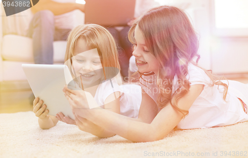 Image of happy little girls with tablet pc computer at home