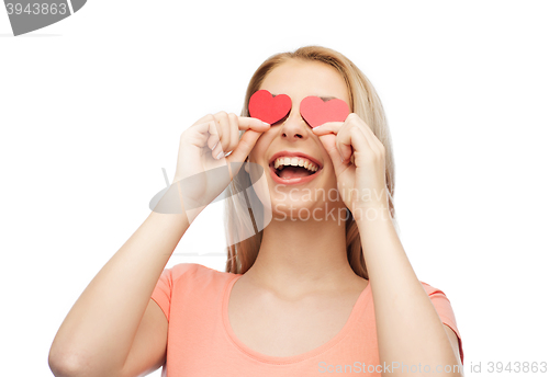 Image of happy young woman with red heart shapes on eyes