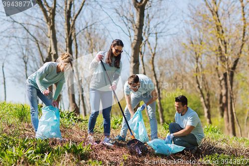 Image of volunteers with garbage bags cleaning park area