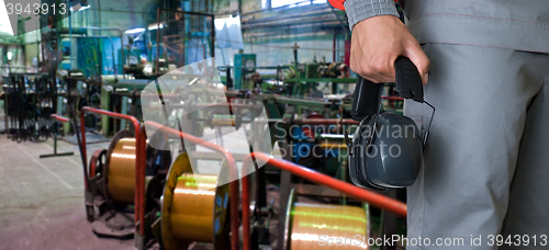 Image of Worker with protective headphone