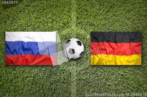 Image of Russia vs. Germany flags on soccer field