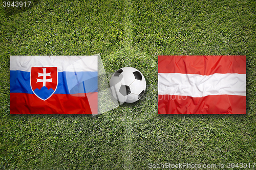 Image of Slovakia vs. Austria flags on soccer field