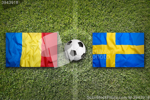 Image of Romania vs. Sweden flags on soccer field