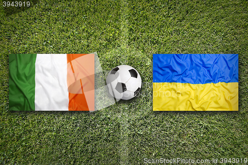 Image of Ireland vs. Ukraine flags on soccer field