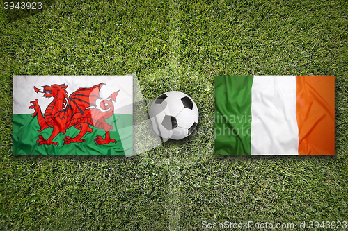 Image of Wales vs. Ireland flags on soccer field