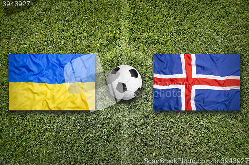 Image of Ukraine vs. Iceland flags on soccer field