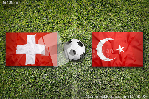 Image of Switzerland vs. Turkey flags on soccer field