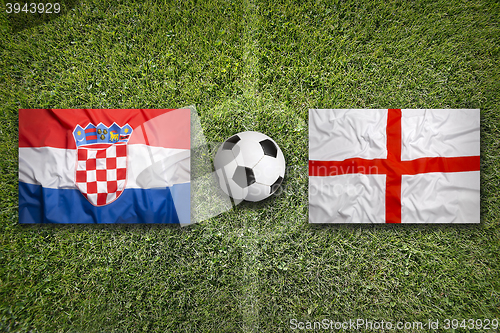Image of Croatia vs. England flags on soccer field