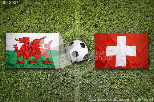 Image of Wales vs. Switzerland flags on soccer field