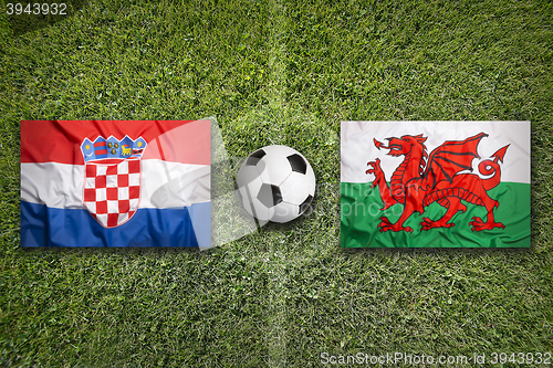 Image of Croatia vs. Wales flags on soccer field