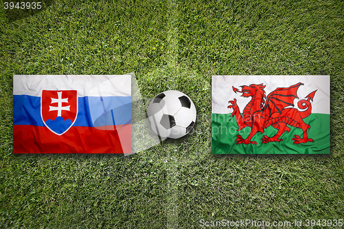 Image of Slovakia vs. Wales flags on soccer field