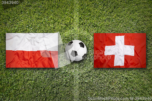 Image of Poland vs. Switzerland flags on soccer field