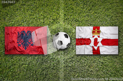 Image of Albania vs. Northern Ireland flags on soccer field