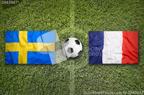 Image of Sweden vs. France flags on soccer field