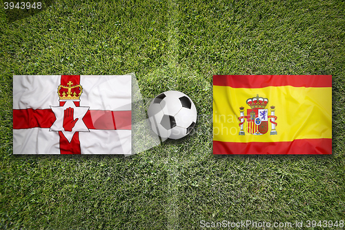 Image of Northern Ireland vs. Spain flags on soccer field