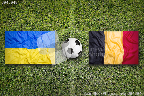 Image of Ukraine vs. Belgium flags on soccer field