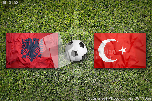 Image of Albania vs. Turkey flags on soccer field