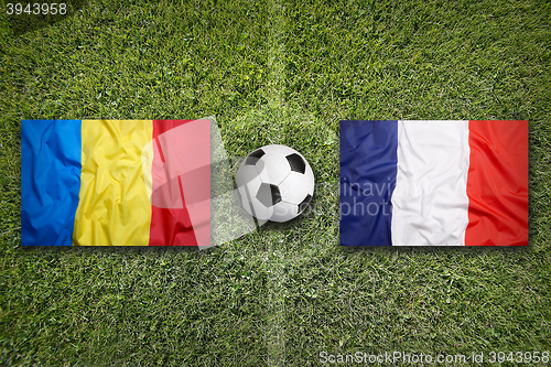 Image of Romania vs. France flags on soccer field
