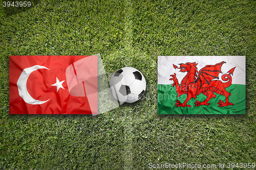 Image of Turkey vs. Wales flags on soccer field
