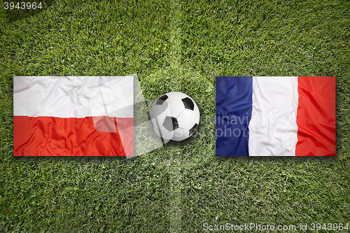 Image of Poland vs. France flags on soccer field
