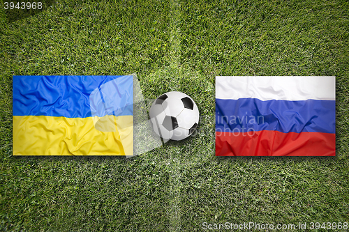 Image of Ukraine vs. Russia flags on soccer field