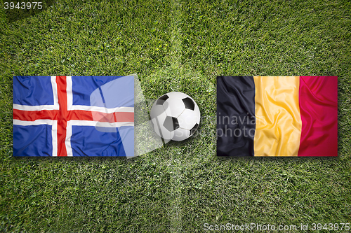 Image of Iceland vs. Belgium flags on soccer field