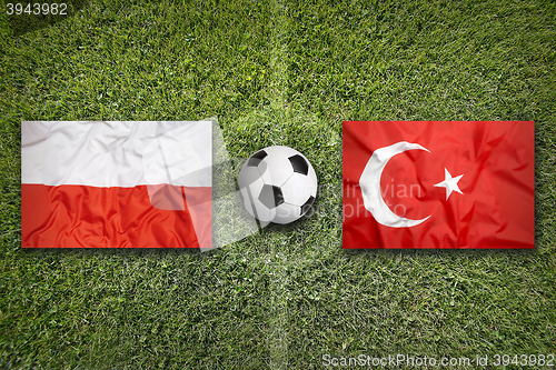 Image of Poland vs. Turkey flags on soccer field