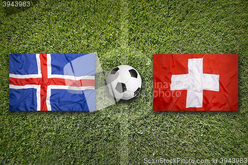 Image of Iceland vs. Switzerland flags on soccer field