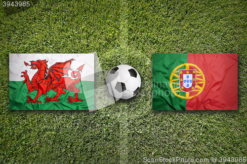 Image of Wales vs. Portugal flags on soccer field