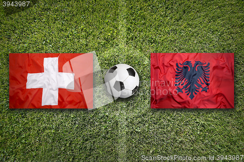 Image of Switzerland vs. Albania flags on soccer field