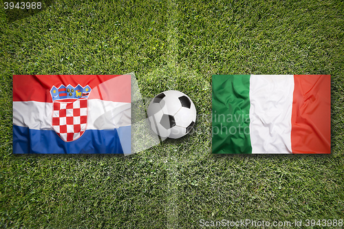Image of Croatia vs. Italy flags on soccer field