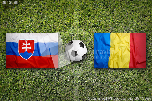 Image of Slovakia vs. Romania flags on soccer field