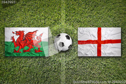 Image of Wales vs. England flags on soccer field