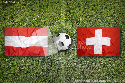 Image of Austria vs. Switzerland flags on soccer field