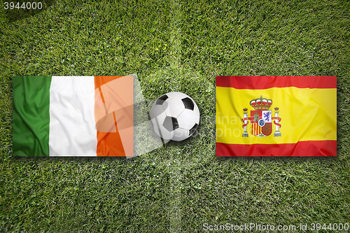 Image of Ireland vs. Spain flags on soccer field