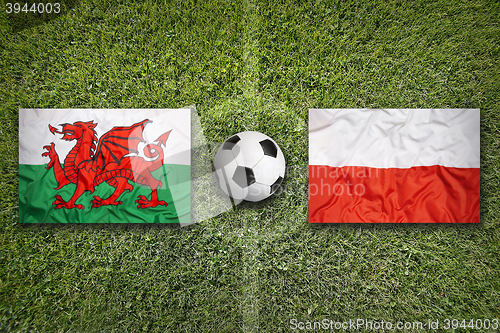 Image of Wales vs. Poland flags on soccer field
