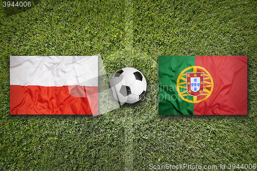 Image of Poland vs. Portugal flags on soccer field