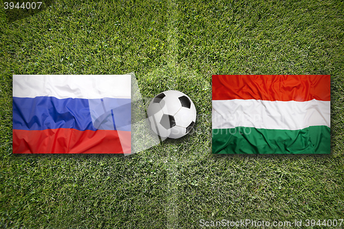 Image of Russia vs. Hungary flags on soccer field