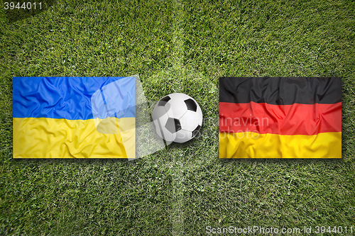 Image of Ukraine vs. Germany flags on soccer field