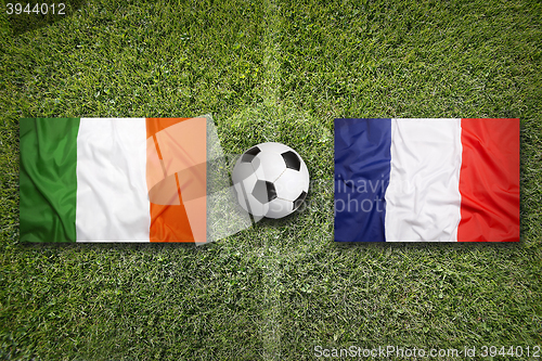 Image of Ireland vs. France flags on soccer field