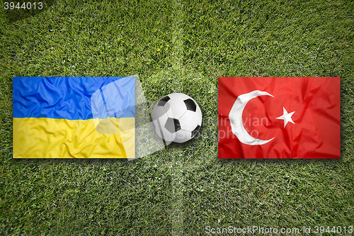 Image of Ukraine vs. Turkey flags on soccer field