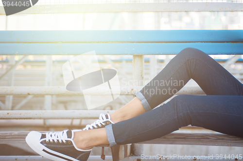 Image of closeup of woman legs in white gumshoes