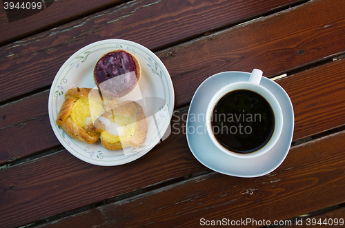 Image of Coffee and pastry on a rustic table