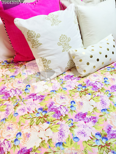 Image of Bed with colorful floral design bedclothes