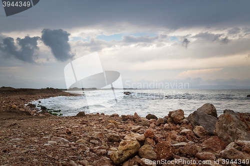 Image of Dark sky, rocky coast and stormy sea