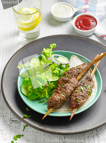 Image of grilled minced meat skewers kebabs