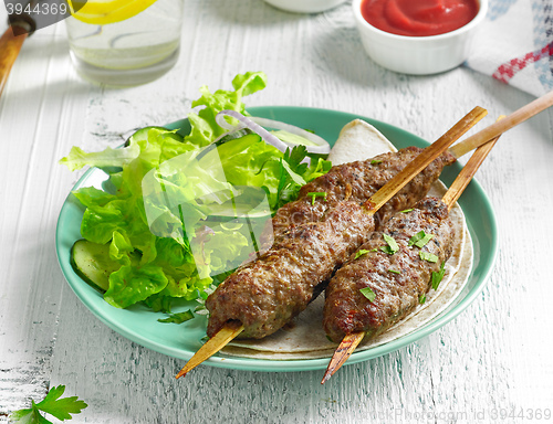 Image of grilled minced meat skewers kebabs