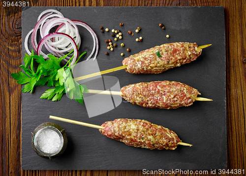 Image of raw minced meat skewers kebabs